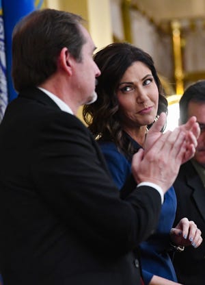 Governor Kristi Noem looks at Speaker of the House Steven Haugaard after thanking him for a comment following her State of the State address on Tuesday, Jan. 14, in the House Chamber at the State Capitol in Pierre.