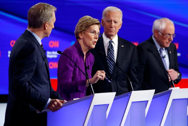Democratic presidential candidate Sen. Elizabeth Warren, D-Mass., second from left, speaks as fellow candidates businessman Tom Steyer, left, former Vice President Joe Biden and Sen. Bernie Sanders, I-Vt., right, listen, Tuesday, Jan. 14, 2020, during a Democratic presidential primary debate hosted by CNN and the Des Moines Register in Des Moines, Iowa.