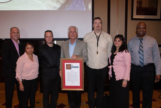 Richard Balocco, president and CEO of Desert Arc, displays the proclamation he presented to Desert Arc on its 60th Anniversary. Present are Glenn Miller, vice chair of the Desert Arc board of directors and mayor of Indio; client honoree Claudia; client honoree Matt; client honoree Brendan; client honoree Veronica and client honoree Kyle.