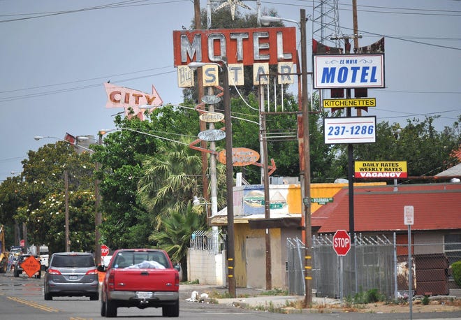 Old motels along Golden State Boulevard with decades old signage. Photo for use with CalMatters