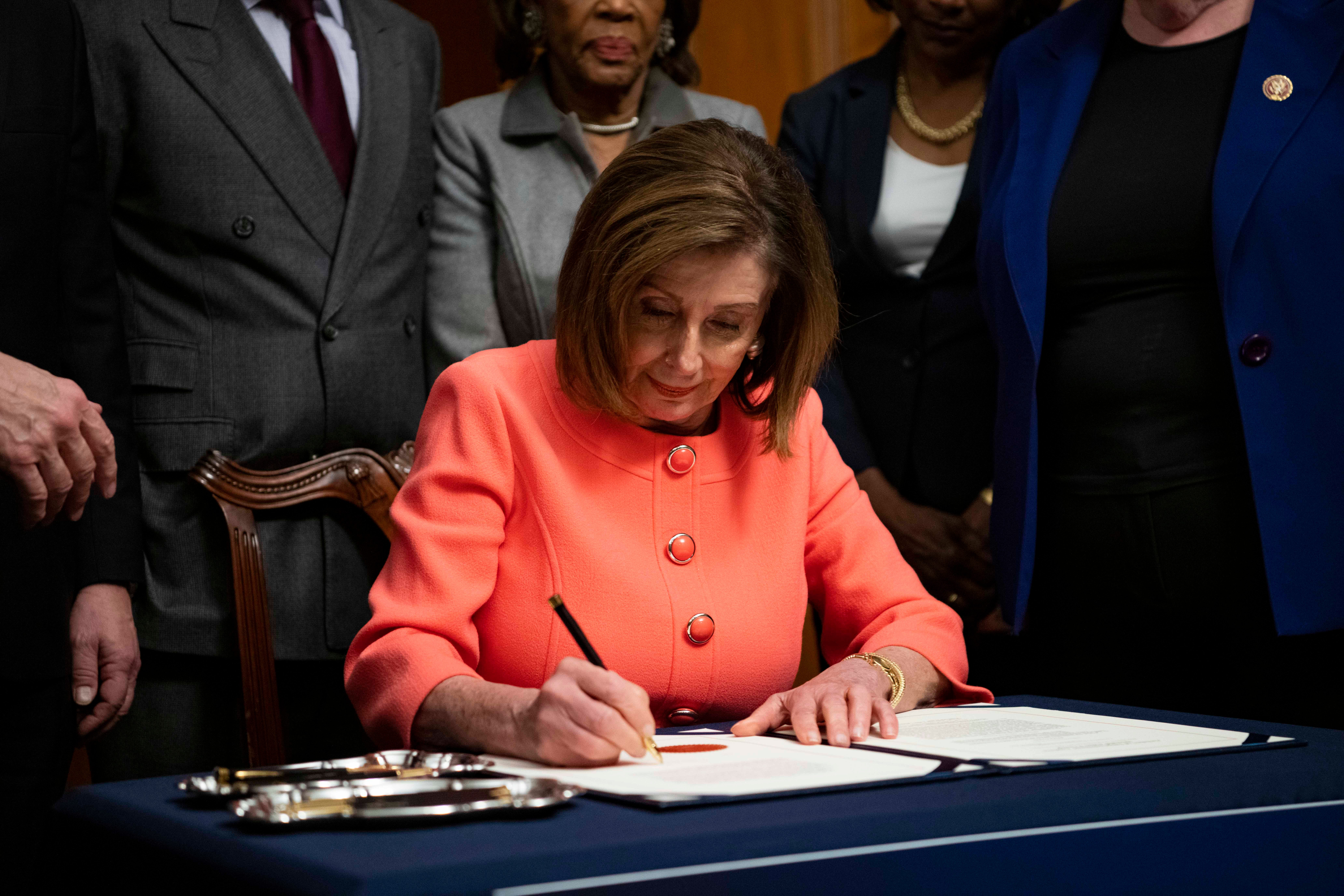 House Speaker Nancy Pelosi uses a plethora of pens to sign articles of impeachment against President Donald Trump.