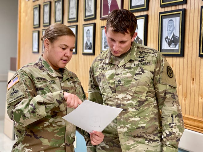 Fort Campbell Warrior Transition Battalion Platoon Sergeant, Sgt. 1st Class Elizabeth Mercedes, speaks with WTB Squad Leader, Staff Sgt. Robert Popa at the battalion. Mercedes was selected as the best platoon sergeant for 2019 in the Army Recovery Care Program Cadre of Excellence Awards for her dedication and support to wounded, ill and injured Soldiers assigned to the Fort Campbell WTB. U.S. Army photo by Maria Yager.
