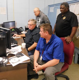 St. Landry Parish computer center employees work with a consulting firm to examine the damage caused by Wednesday morning's cyber threat on the district's computer system. Charles Morrison, a consultant with Cohesive Connections and district computer employees John Kittle (background) and Edmond Reed work with Morrison on the problem Thursday morning at the computer center.