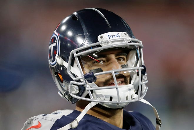 FILE - In this Nov. 24, 2019, file photo, Tennessee Titans quarterback Marcus Mariota looks at the scoreboard in the second half of an NFL football game against the Jacksonville Jaguars in Nashville, Tenn. The Tennessee Titans benched Mariota for Ryan Tannehill in mid-October after a 2-4 start.