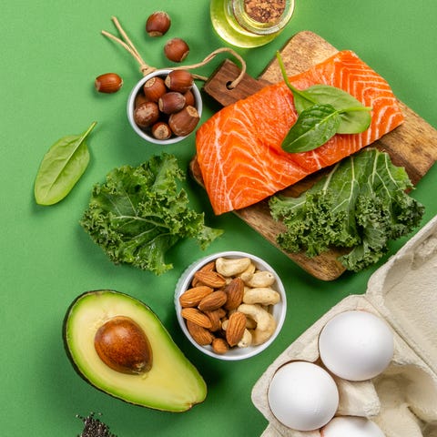 Keto diet concept - salmon, avocado, eggs, nuts an