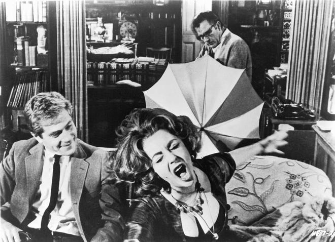 George Segal (from left), Elizabeth Taylor and Richard Burton (back) star in the marital black comedy