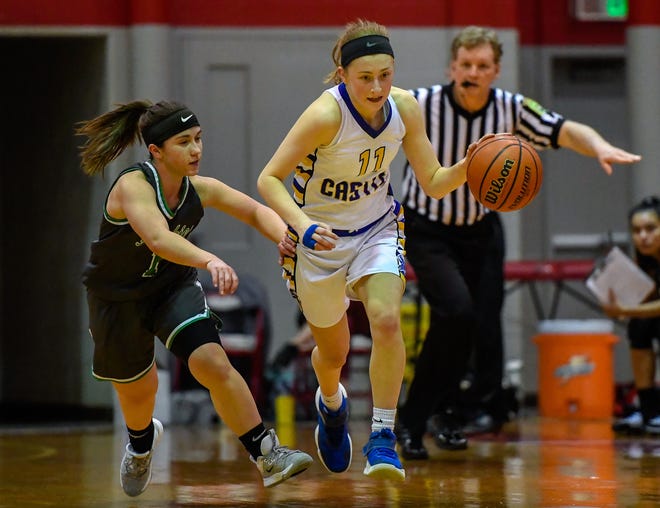 Castle's Carly Harpenau (11) brings the ball up under pressure from North’s Maddie Haynes (1) as the Castle Knights play the North High Lady Huskies in the girls Southern Indiana Athletic Conference tournament semi-finals at Bosse High Thursday evening, January 16, 2020.
