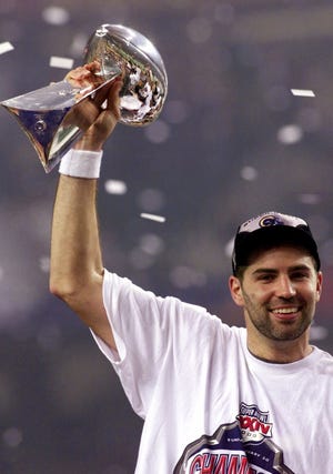St. Louis Rams quarterback Kurt Warner holds up the Super Bowl trophy after the Rams defeated the Tennessee Titans 23-16 in Super Bowl XXXIV Jan. 30, 2000 in Atlanta. Warner was named Most Valuable Player in the game.