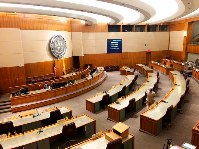 Clerks prepare the state Senate chamber in New Mexico for the arrival of legislators in Santa Fe, N.M., on Thursday, Jan. 16, 2020.