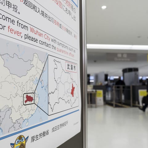 A passenger walks past a notice for  passengers fr