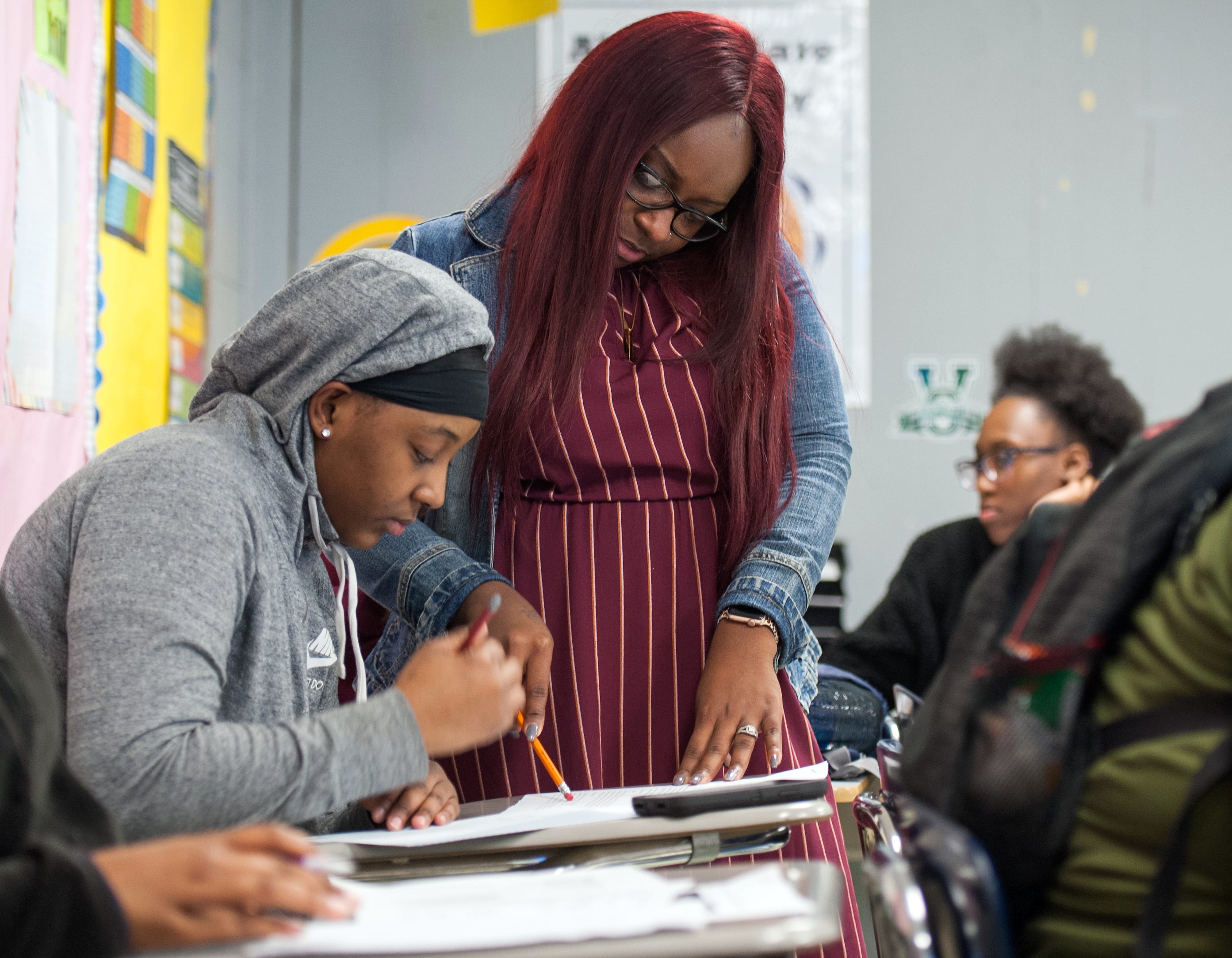 Second-year English teacher Samara Rand goes over a passage with a student at Holmes County Central High School, ranked one of the lowest performing in Mississippi.