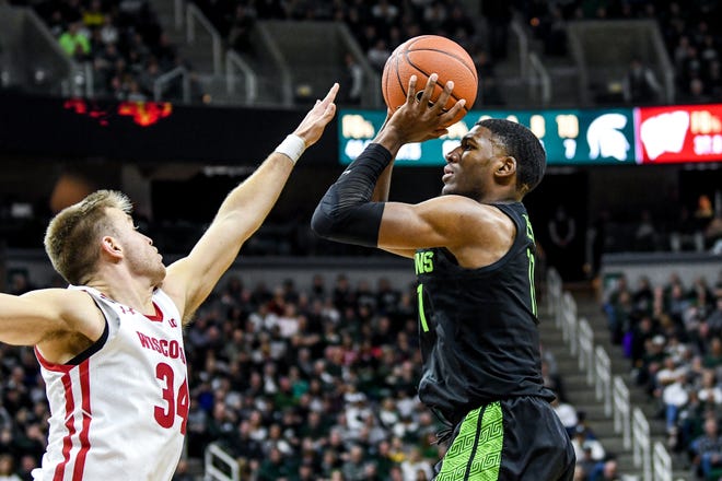 Michigan State's Aaron Henry, right, shoots as Wisconsin's Brad Davison defends during the second half on Friday, Jan. 17, 2020, at the Breslin Center in East Lansing.