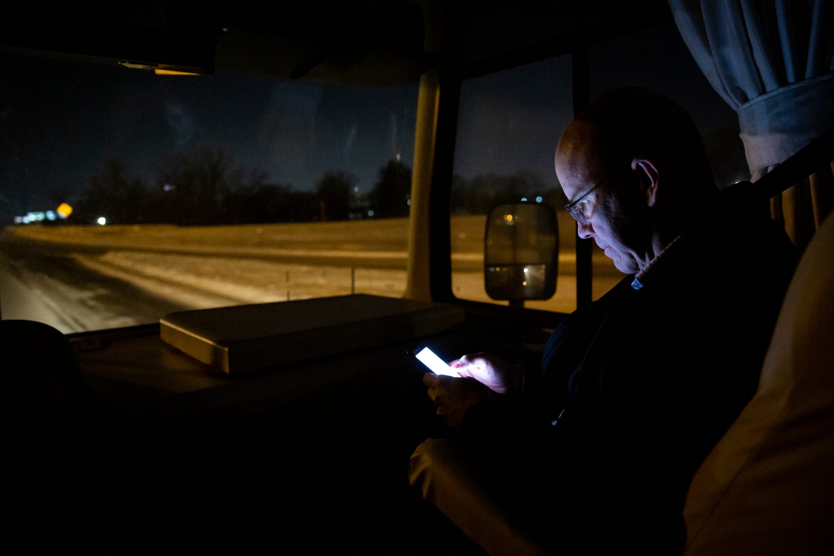 6:57 p.m., on the way to Des Moines — John Delaney checks his phone while heading back to Des Moines after speaking at the Story County Democrats' Soup Supper fundraiser in Ames.