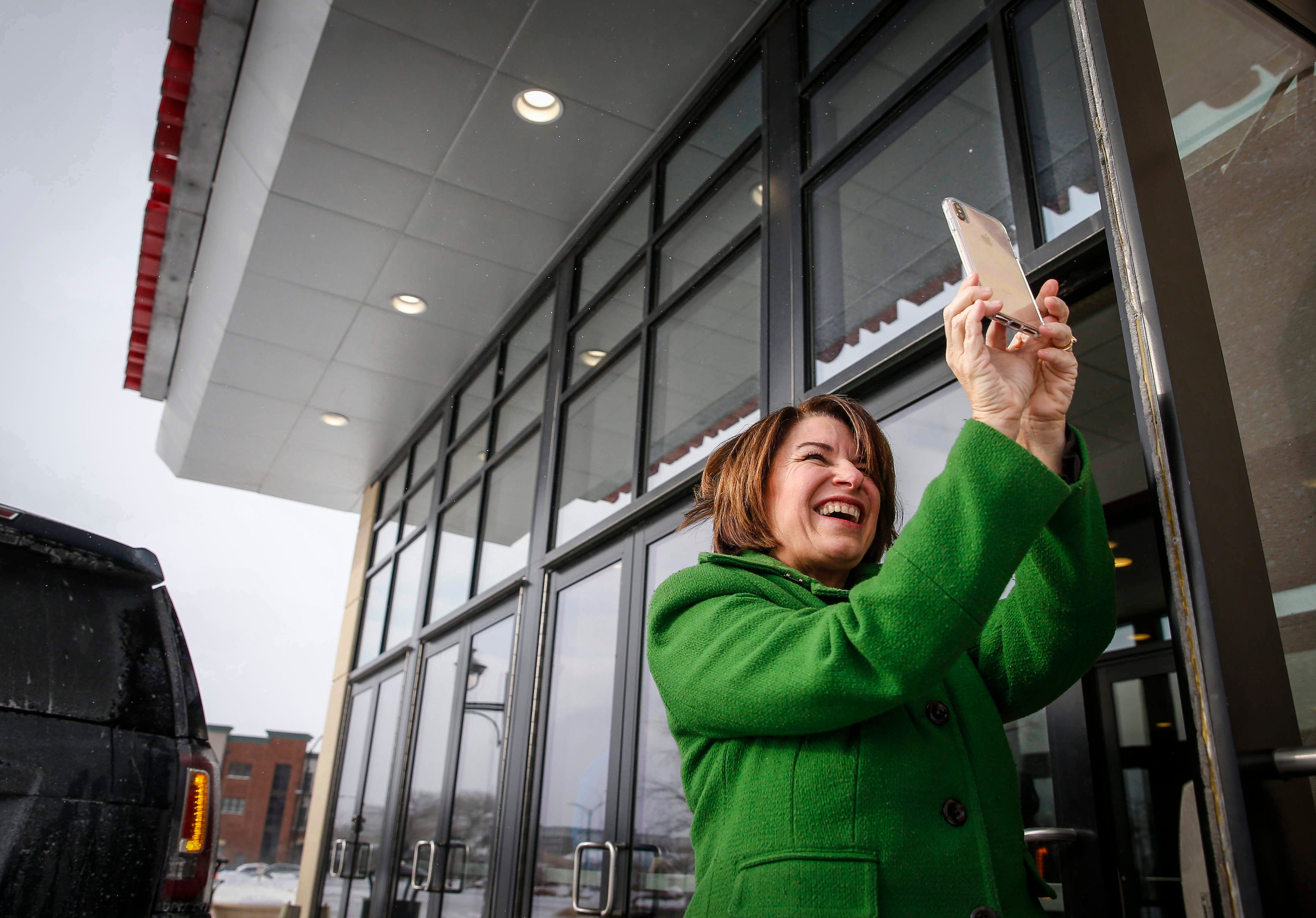 1:47 p.m., Coralville — "Oh, look at that lovely trash can," Amy Klobuchar says while composing a photo of ice formed on the trees outside the Coralville Marriott Hotel & Conference Center after speaking to a crowded room.