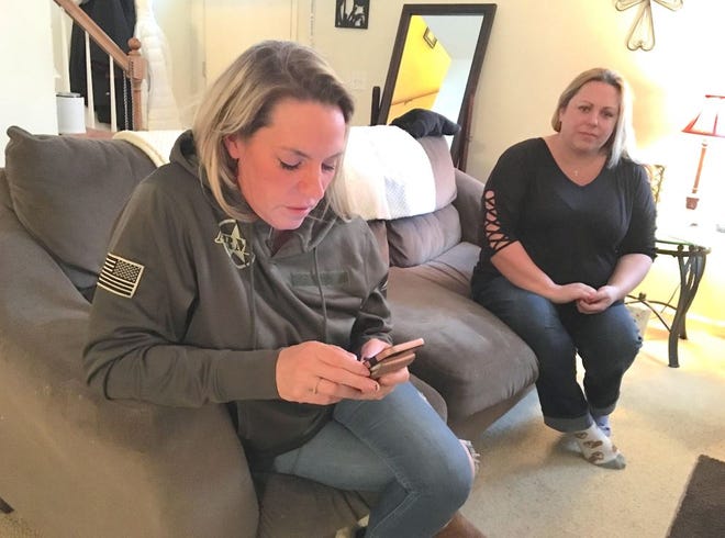 Jessica Schojan tries connecting with her son, Jake Schojan, an Army paratrooper/combat engineer serving in Kuwait. Jessica Bell looks on. They were also able to reach Bell's son, Tyler Bell, a Marine serving in Iraq, by phone.