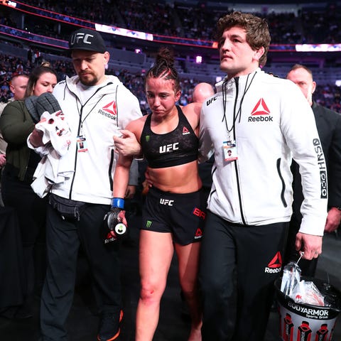 Maycee Barber gets helped out of the octagon after