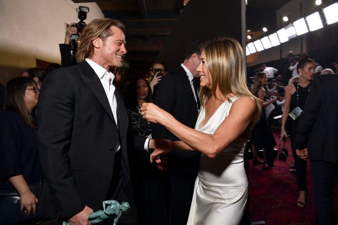 Brad Pitt and Jennifer Aniston greet each other backstage.