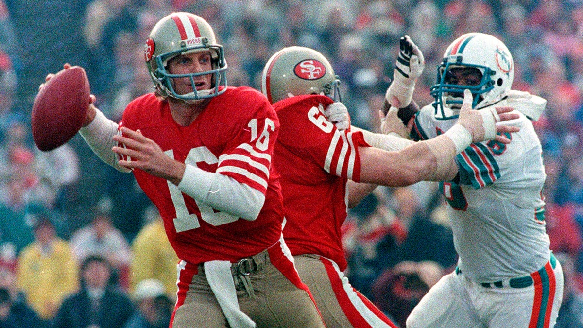In this Jan. 20, 1985, file photo, San Francisco 49ers quarterback Joe Montana (16) looks for a receiver behind protective blocking of left guard John Ayers (68) against Miami Dolphins' Don McNeal during the first half of NFL football's Super Bowl XIX in Palo Alto, Calif.