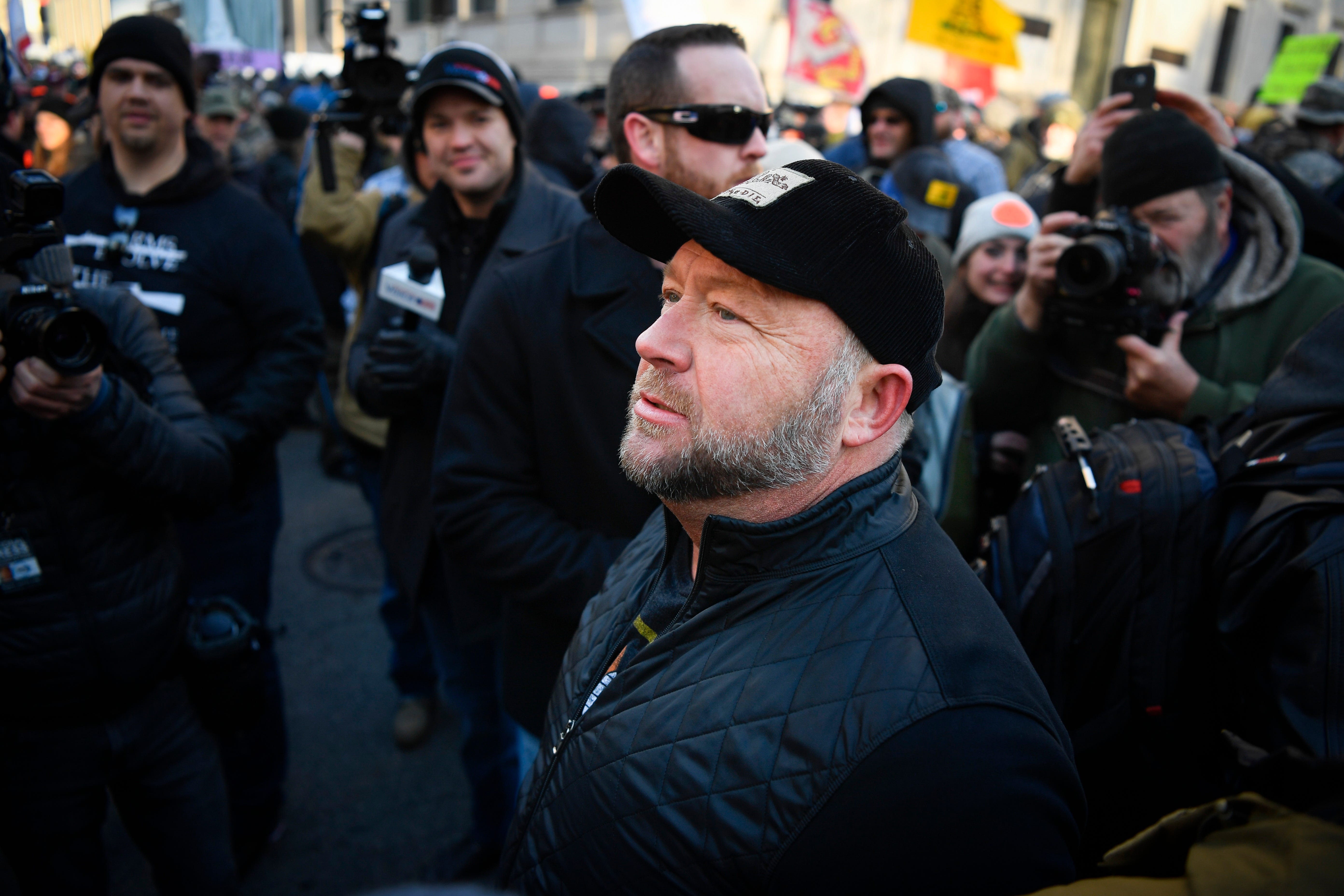 Alex Jones, right, radio host of Infowars, joins gun rights advocates and militia members gathering in Virginia's capitol to protest potential gun control bills.