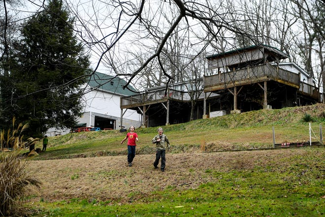 Children run across the backyard of ZigZag, an unschooling collective in Asheville. Unschooling is a student-driven form of homeschooling.