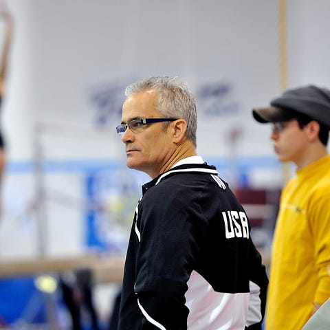 Coach John Geddert watches as World Champion gymna