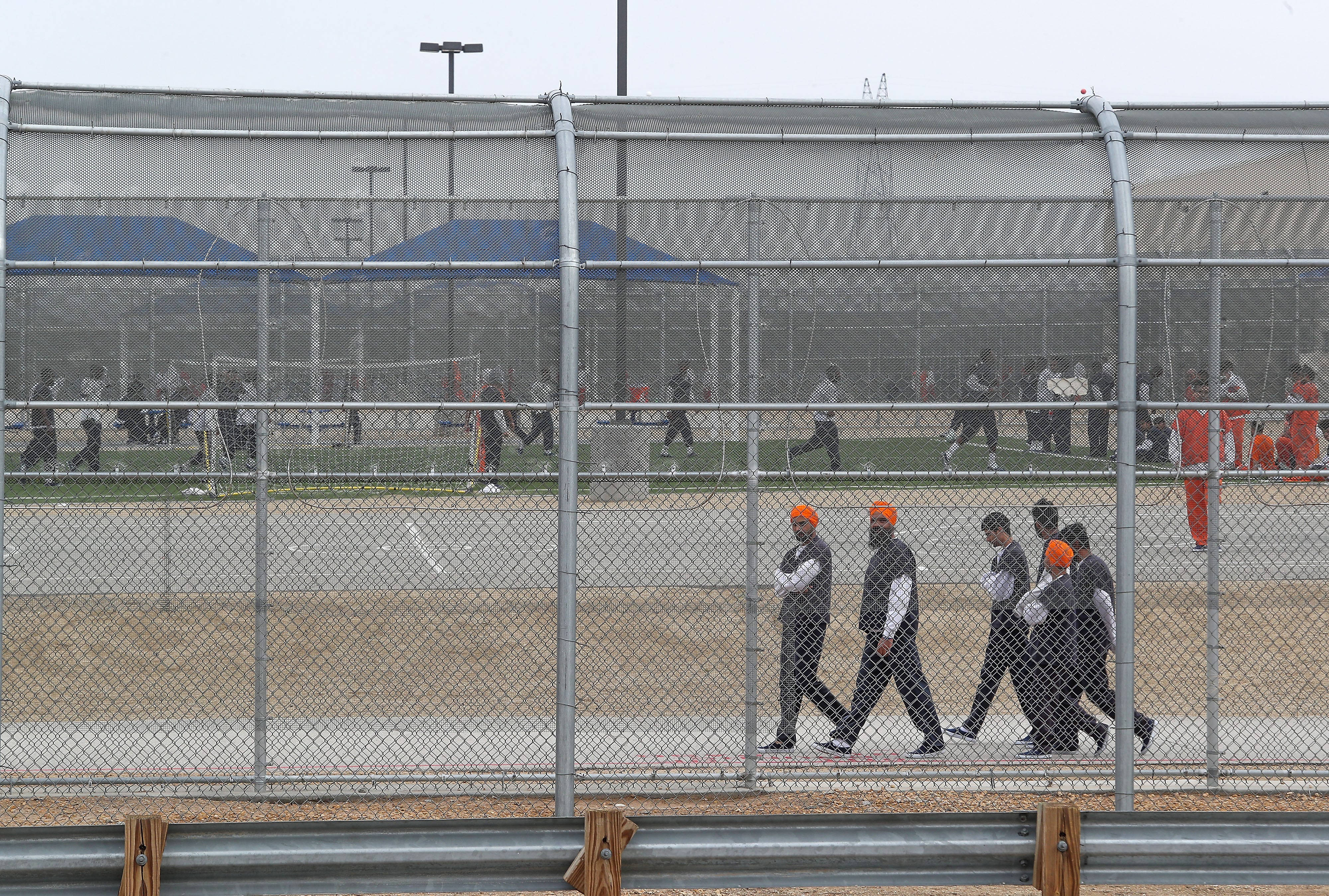 Detainees walk around outside at the U.S. Immigration and Customs Enforcement's Adelanto Processing Center in Adelanto.