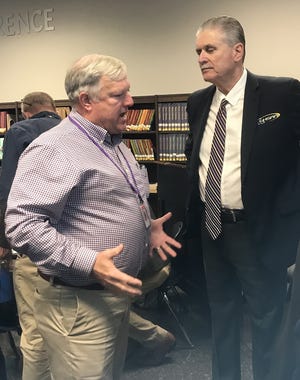 Byrd principal Jerry Badgley makes a point with LHSAA executive director following Tuesday's 2020 area meeting at Airline High School.