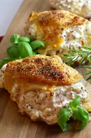 Cheesy Herb Stuffed Chicken Breasts are stuffed with three kinds of cheese, chopped roasted pecans and fresh herbs.