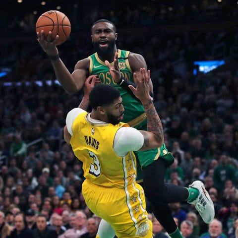 Boston Celtics guard Jaylen Brown drives to the ba