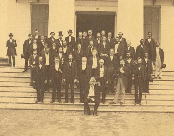 The Alabama State Senate in 1872. Jeremiah Haralson is at the right end of the third row from the bottom, holding a top hat.