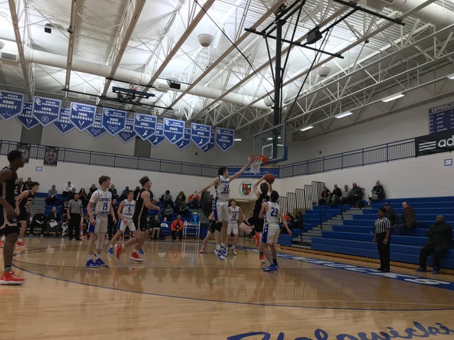Brother Rice freshman guard Henry Garrity finishes at the rim against Detroit Catholic Central