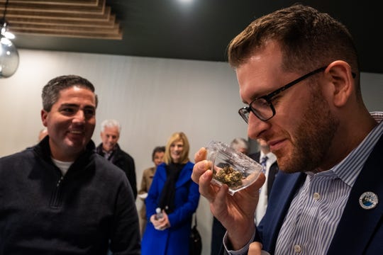 Port Huron City Councilman Jeff Pemberton inspects a special container holding medical marijuana Tuesday, Jan. 21, 2020, at LIV Ferndale. The special container is designed to let patients inspect different products without physically touching them.