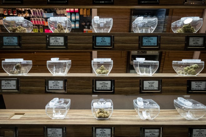 Different types of medical marijuana are arranged in containers on a shelf at LIV Ferndale. Port Huron officials toured the facility.