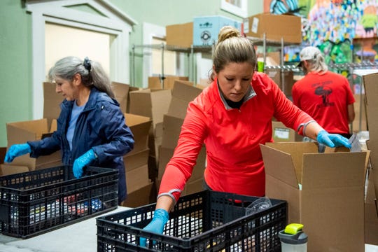 Volunteers assemble grocery orders on Wednesday, Oct. 2, 2019 at Sprout in Battle Creek, Mich. 