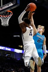 Xavier Musketeers forward Tyrique Jones (4) pushes past a block from Georgetown Hoyas guard Mac McClung (2) on a dunk in the first half of the NCAA Big East basketball game between the Xavier Musketeers and the Georgetown Hoyas at the Cintas Center in Cincinnati on Wednesday, Jan. 22, 2020.