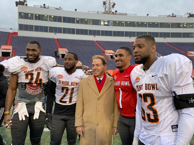 Alabama head coach Nick Saban (center) is pictured beside former Alabama players Terrell Lewis (24), Jared Mayden (21), Jalen Hurts (1), and Anfernee Jennings (33) following Wednesday's South Team practice for the 2020 Senior Bowl at Ladd-Peebles Stadium in Mobile.