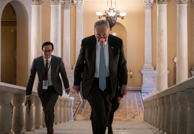 Senate Majority Leader Chuck Schumer, D-N.Y., takes the stairs to speak to reporters about progress in the impeachment trial of President Donald Trump on charges of abuse of power and obstruction of Congress, at the Capitol in Washington, Thursday, Jan. 23, 2020.
