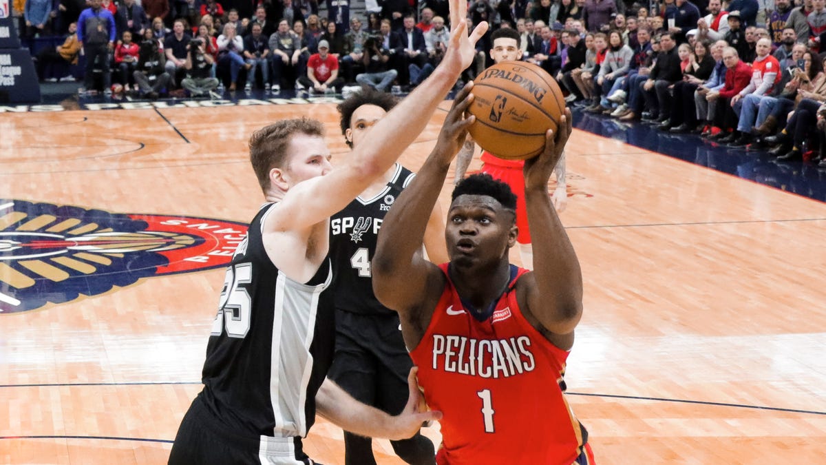 Pelicans forward Zion Williamson drives past Spurs center Jakob Poeltl (25) during the fourth quarter at the Smoothie King Center.
