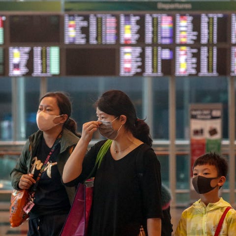 A mother and her children are seen wearing masks w