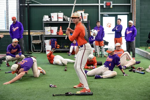 Clemson junior Bryce Teodosio (13), middle, uses a pvc pipe warming up during the first official team Spring practice at Doug Kingsmore Stadium in Clemson Friday, January 24, 2020.