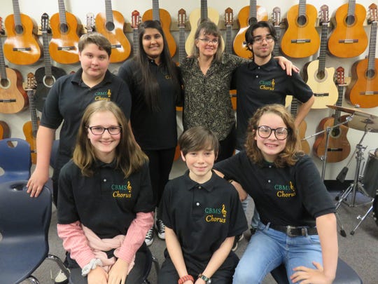 Several members of the Cedar Bluff Middle School’s vocal ensemble relax in their classroom on Jan. 22, 2020. Front row, from left, are Ari Rathe, Solomon Murakami and Kate Crass. Back row: Ian Beatty, Noor Alsaadun, teacher Edie Taylor, and Allan Rodriguez.