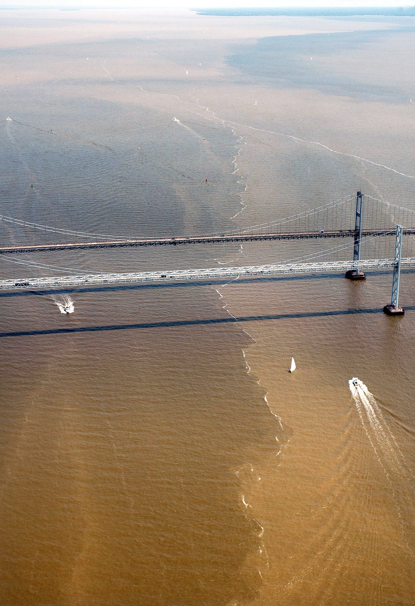 Sediment-laden plumes converge around the Chesaspeake Bay Bridge in Maryland following huge rainstorms in 2006.