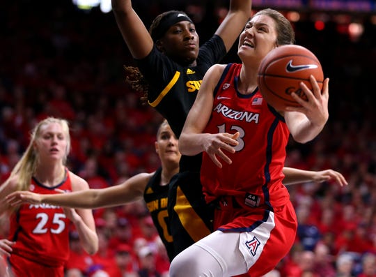 Arizona State Sun Devils forward Ja'Tavia Tapley (33) is shoved out of the way by Arizona Wildcats guard Helena Pueyo (13) as Pueyo drives the ball to the basket during a game at the McKale Center, on Jan. 24, 2020.