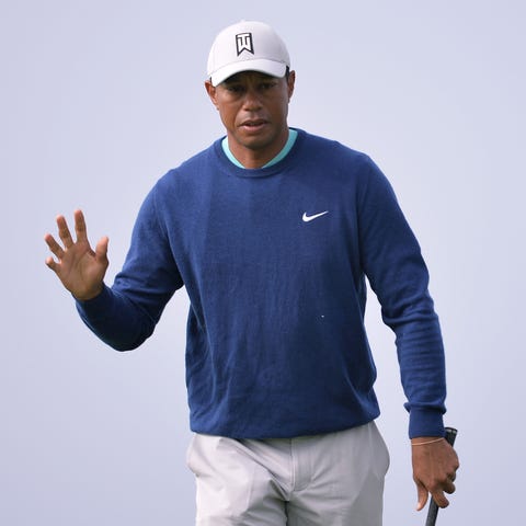 Tiger Woods acknowledges the crowd after chipping 