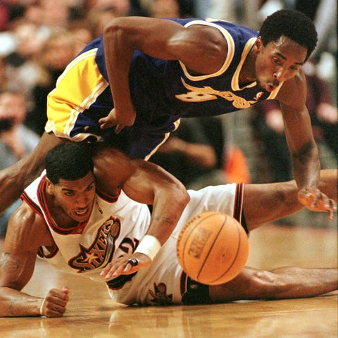 The Los Angeles Lakers' Kobe Bryant (top) flips ov