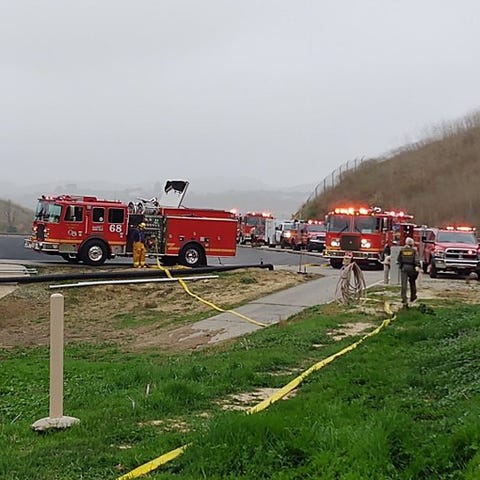 Fire and law enforcement officials surround near t