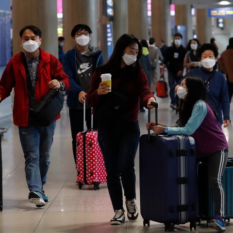 Passengers wear protective masks at Incheon Intern