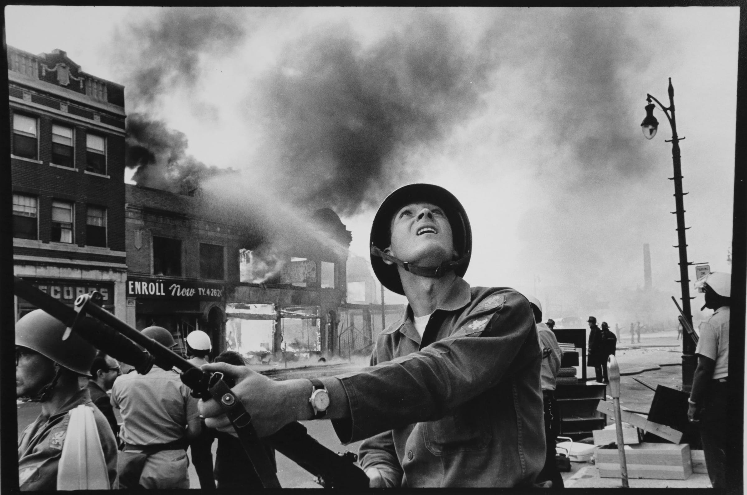 National Guardsman Gary Ciko of Hamtramck checks on buildings for snipers during the riot on July 23,1967 in Detroit.