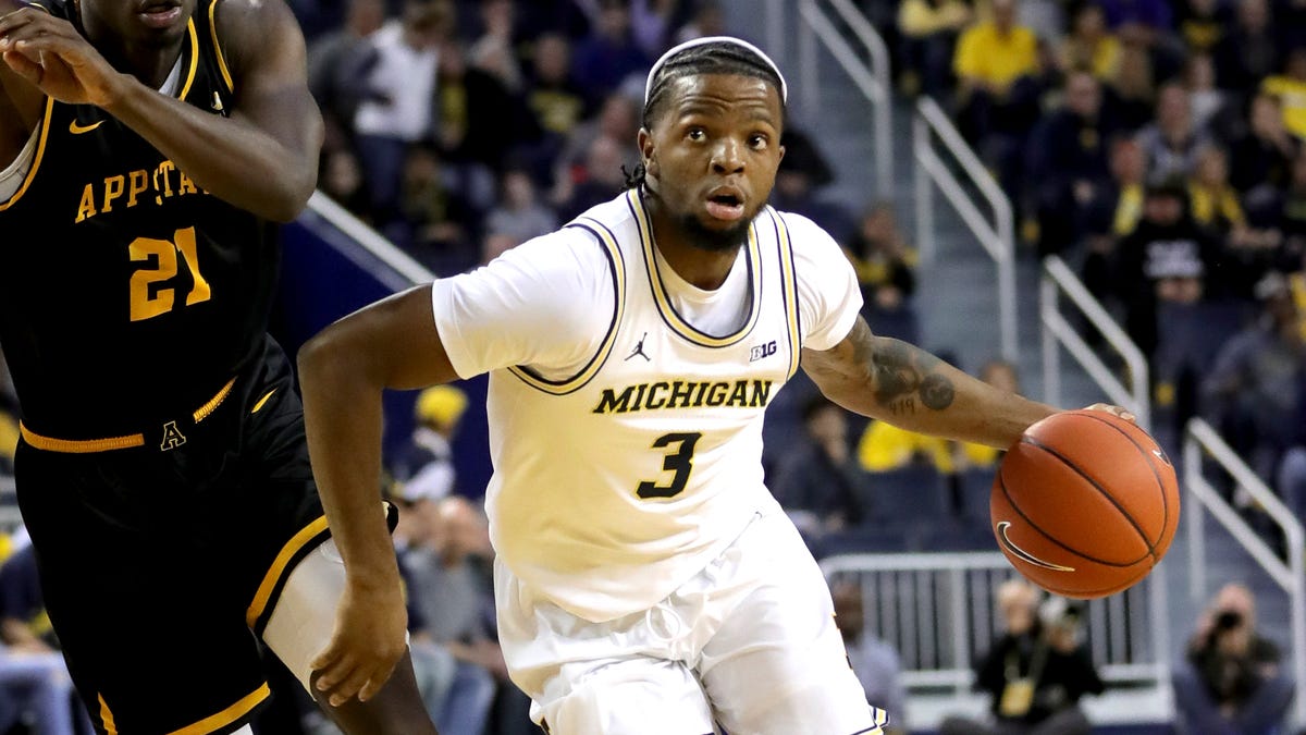 Michigan Wolverines guard Zavier Simpson (3) drives againstAppalachian State Mountaineers forward James Lewis Jr. (21) during first half action Tuesday, November 5, 2019 at the Crisler Center in Ann Arbor, Mich.
