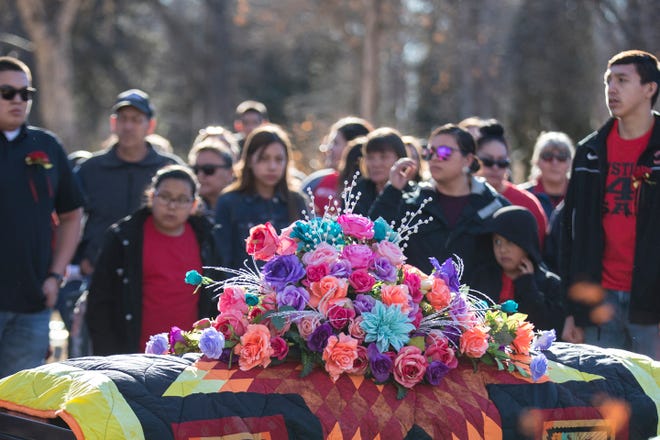 Flowers rest on top of Selena Not Afraid's casket during her funeral at the Fairview Cemetery in Hardin, Mont. on Sunday.